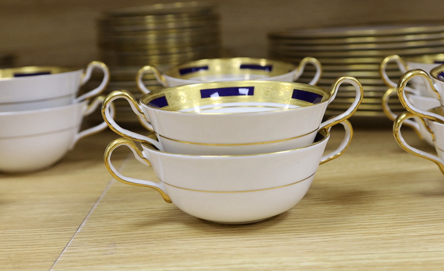 An Aynsley blue and gilt part dinner service